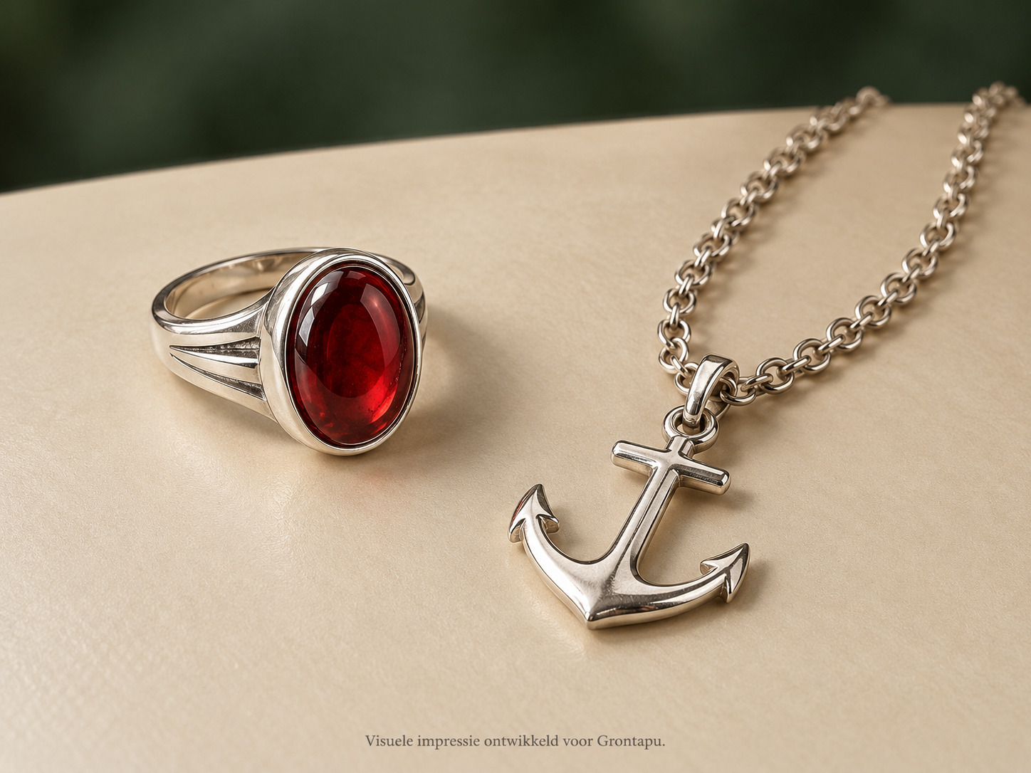 Ankerhanger en zilverkleurige ring met rode steen